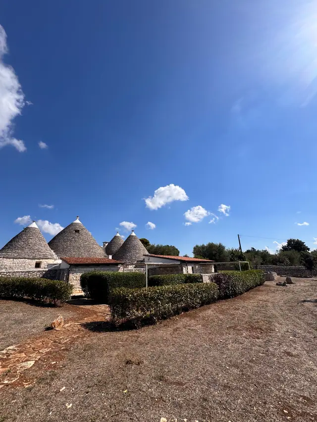 Trulli con siepi potate e terreno pulito